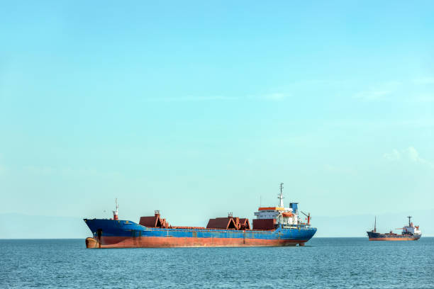 istock Cargo ship or bulk carrier moored in the gulf. A bulk carrier, bulk freighter or colloquially, bulker is a merchant ship specially designed to transport unpackaged bulk cargo, such as grains, coal, ore, and cement in its cargo holds. 1170115459