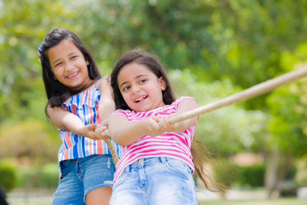 istock Kids pulling the rope - stock photo 1170121492