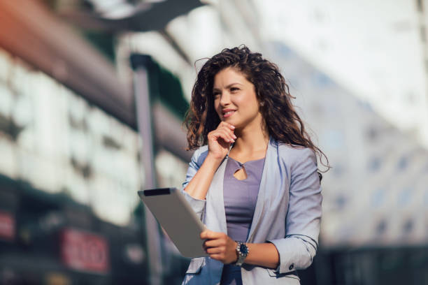 istock Young business woman using digital tablet outdoor 1170121898