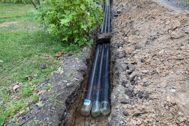 istock Three plastic water pipes in the pit, during repair work. 1170124496