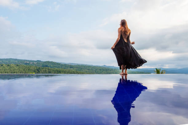 istock Beautiful woman by the pool 1170128941