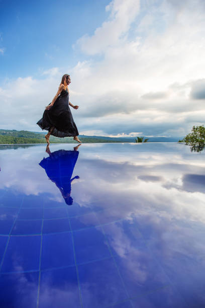 istock Beautiful woman by the pool 1170128948