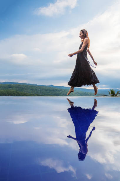 istock Beautiful woman by the pool 1170128963