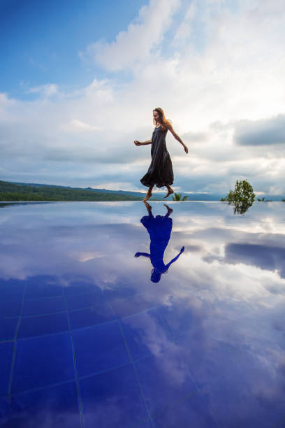 istock Beautiful woman by the pool 1170128974