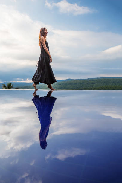 istock Beautiful woman by the pool 1170129003