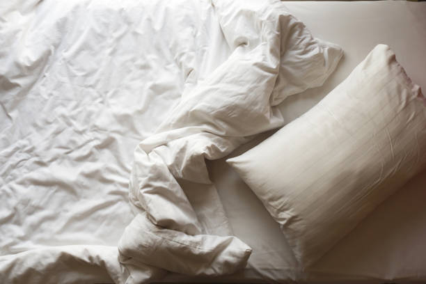 istock Messy bed. Top view with copy space. Concept of relaxation and rest time. 1170132703