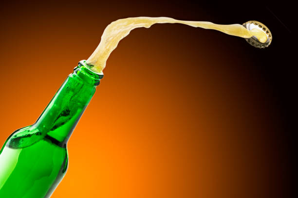 istock Beer splashes fly off the bottle, background. Place for text 1170133812