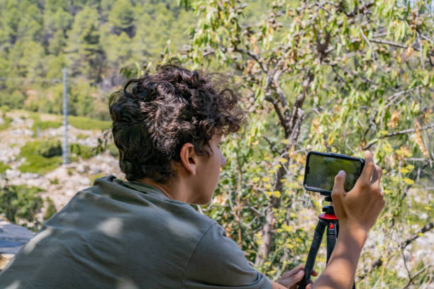 istock Young man photographing 1170135063