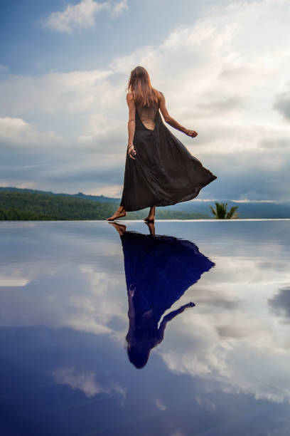 istock Beautiful woman by the pool 1170137438
