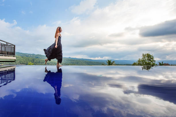 istock Beautiful woman by the pool 1170137440
