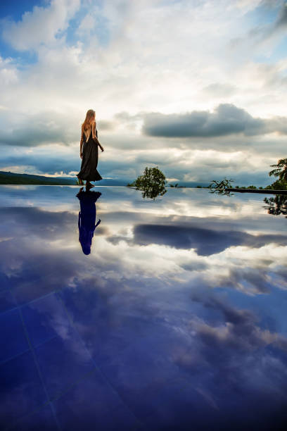 istock Beautiful woman by the pool 1170137448