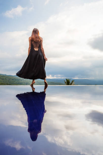 istock Beautiful woman by the pool 1170137455