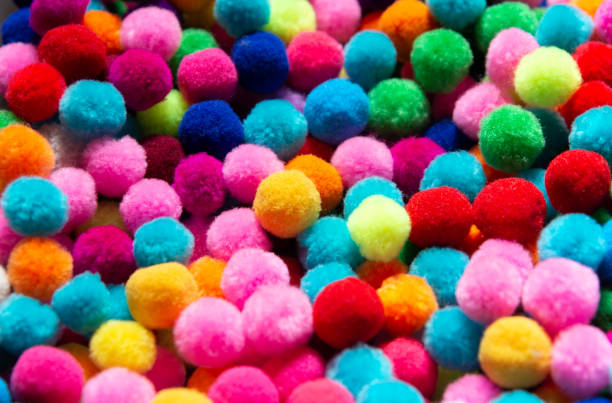 istock A colorful pom poms background 1170138494
