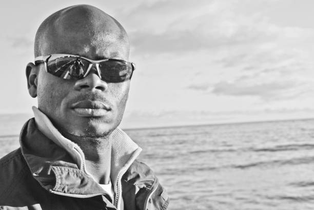 istock Male model posing by a shore. Black and white 1170138526