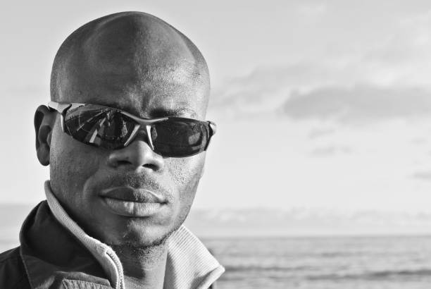 istock Male model posing by a shore. Black and white 1170138674