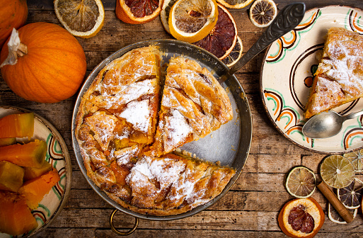 Homemade pumpkin pie and ingredients, autumn season dessert
