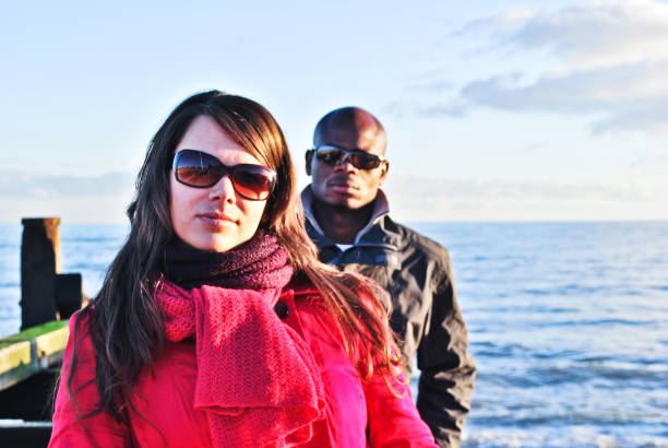 istock Serious looking male and female models posing by a shore. 1170140056