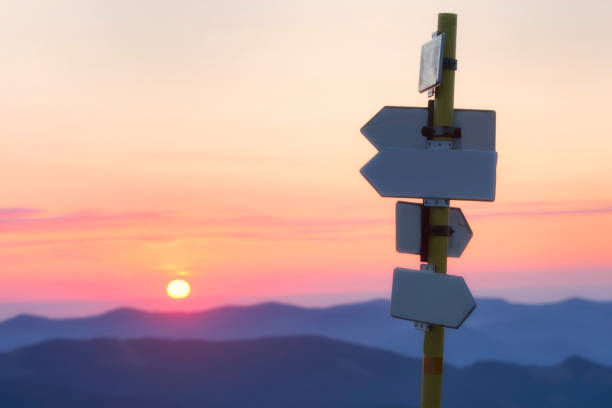 istock Road sign against the rising sun. Crossroads. Pointer for tourists. 1170140821