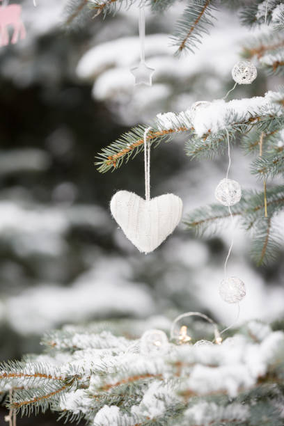 istock Nice decorations on a Christmas tree with snow outdoors. Celebration, winter and holidays concept 1170145461