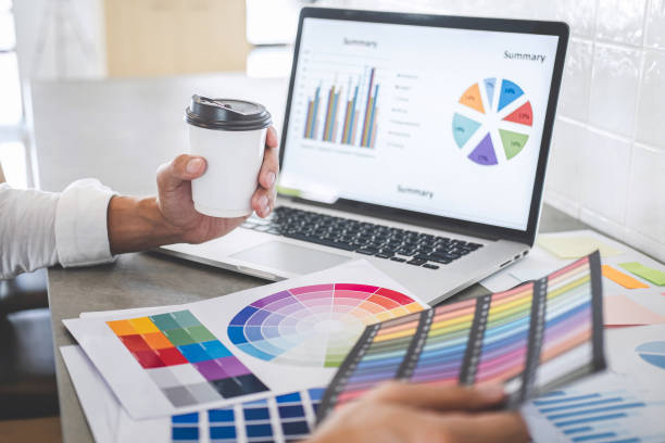 istock Young creative graphic designer working on project architectural drawing and color swatches, selection coloring on graphic chart with work tools and equipment 1170147413