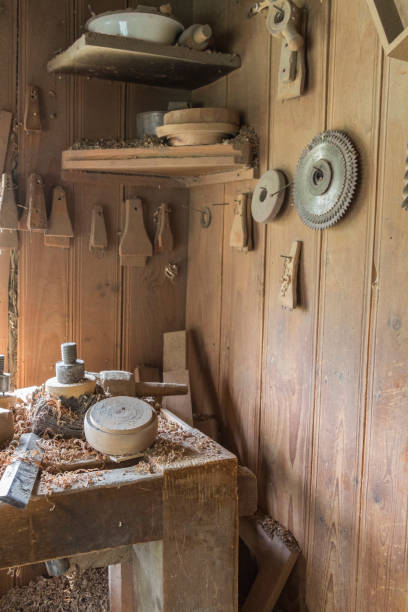 istock Vintage woodworking tools on a workbench and on the wall, dust, and shavings: carpentry, craftsmanship and handwork concept. part of the frame 1170152463