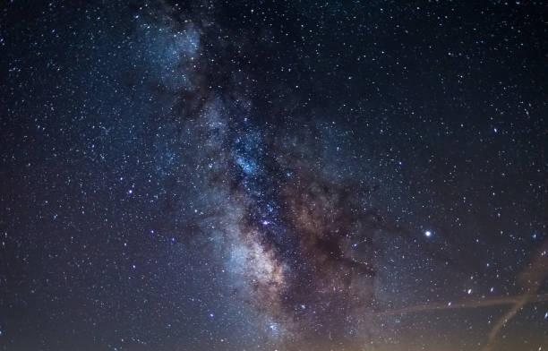 istock Milky way galaxy core and jupiter planet glowing in a bright starry night sky. Christmas background, astronomy, star gazing. 1170152643