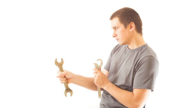 istock young mechanic man holding wrench tool for repair 1170153719