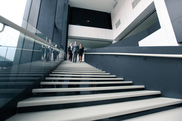 istock Business people walking down stairs 1170153893