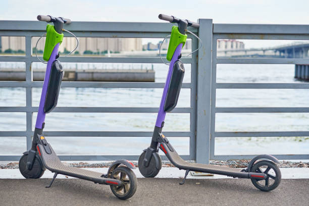 Two electric scooters for in the city. Modern urban transport Two electric scooters for in city. Modern urban transport lime scooter stock pictures, royalty-free photos & images