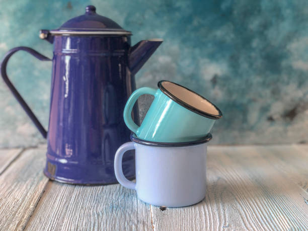 istock blue colored enamel teapot and mugs on a wooden table 1170155029