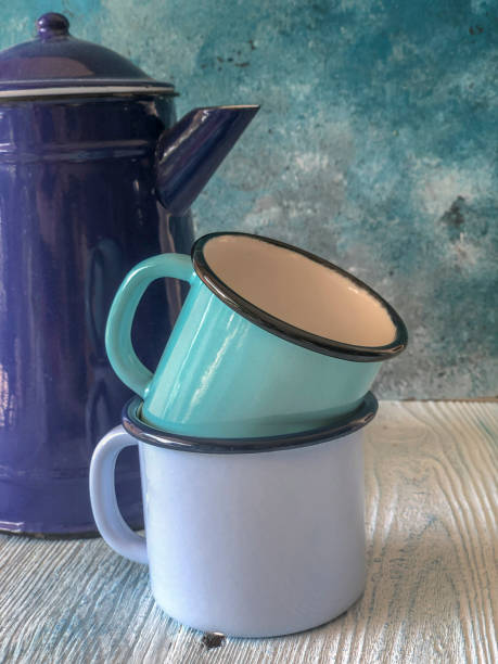 istock blue colored enamel teapot and mugs on a wooden table 1170155030