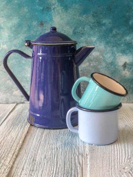 istock blue colored enamel teapot and mugs on a wooden table 1170155031