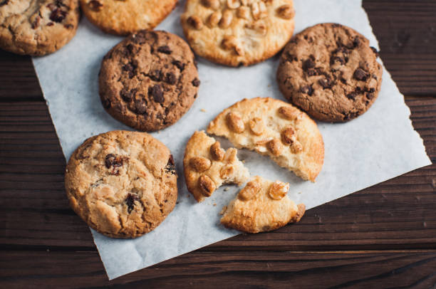 istock Chocolate cookies on parchment paper. Broken biscuits on a wooden table. Selective focus. 1170156197