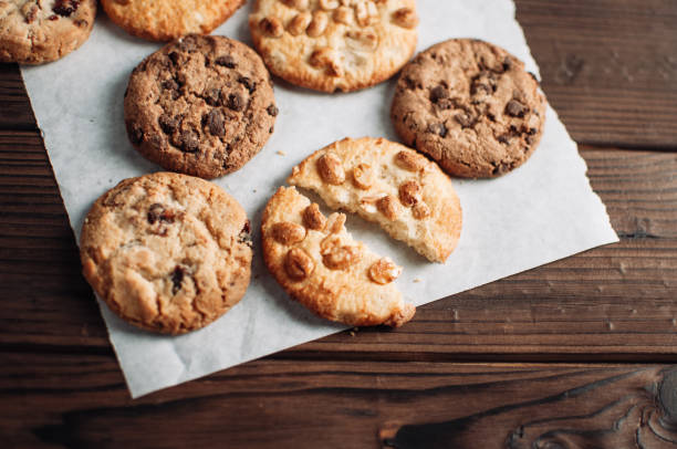 istock Chocolate cookies on parchment paper. Broken biscuits on a wooden table. Selective focus. 1170156287