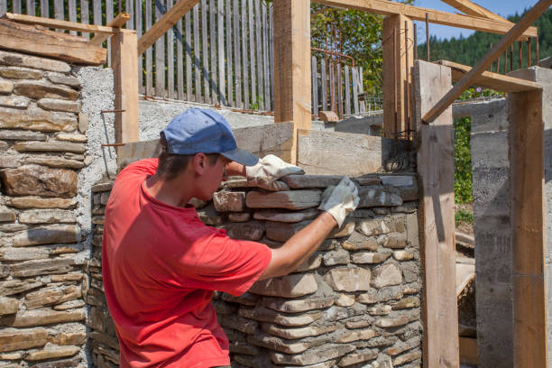 istock man building stone wall for house construction 1170160941