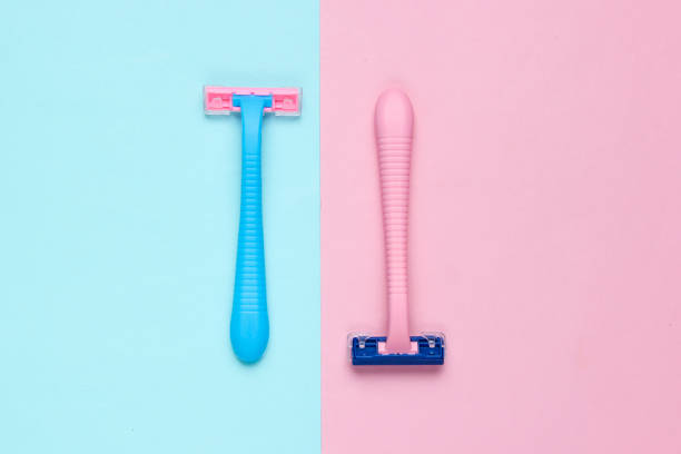 istock Minimalistic beauty concept. Two plastic razor on blue pink pastel background. Top view 1170162298