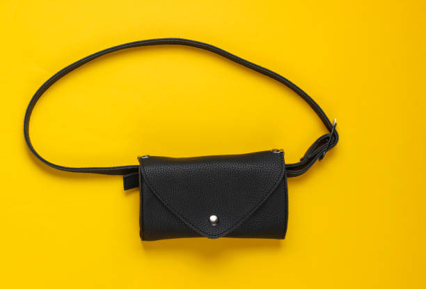 istock Stylish belt bag on yellow background. Top view 1170162340