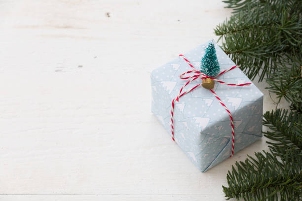 istock Packing Christmas gifts box on white wooden table. Top view with copy space 1170162948