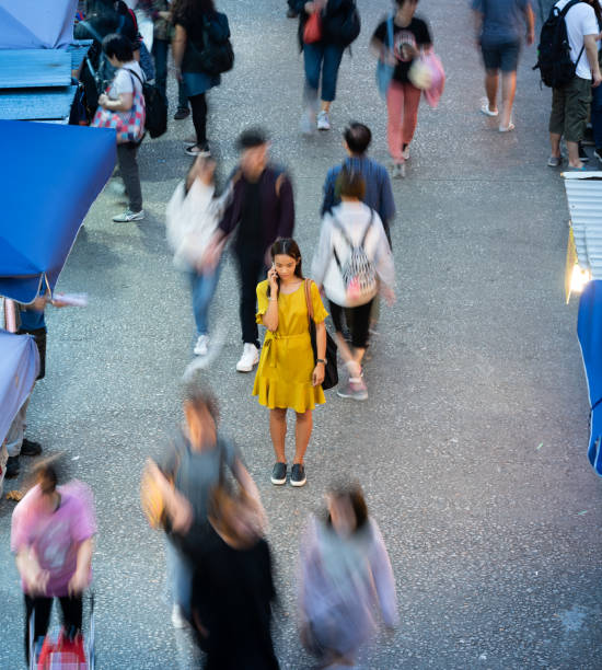 istock Woman using phone, motioned blurred market 1170164300