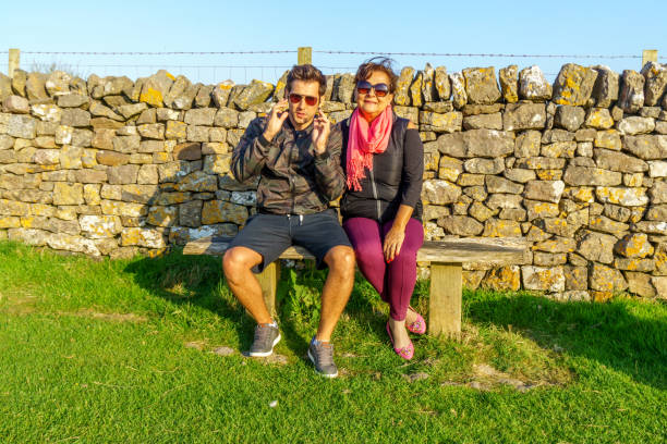 istock Mother and son sitting on bench 1170164888