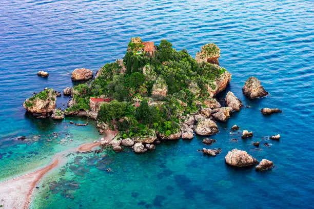Taormina, Sicily, Italy: Beautiful landscape and seascape with beach and island Isola Bella at sunset, aerial view