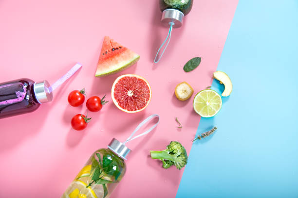 istock Glass bottles with natural drinks on a colored background 1170166575