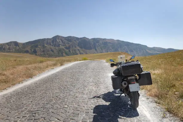 Beauty motobike on lanscape long road and field with mount