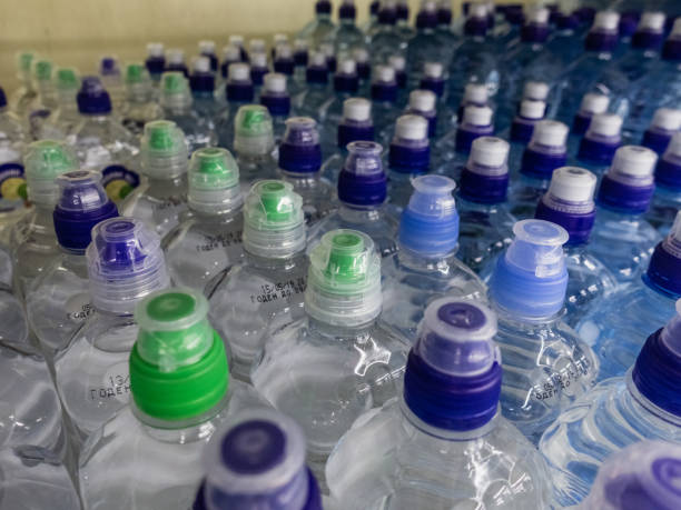 istock Plastic bottles with wate. Rows of water-filled plastic bottles with screw caps. 1170171423