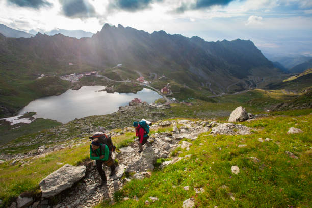 istock people climbing the mountain landscape 1170172810