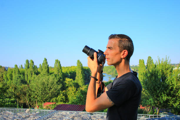 istock Photographer shooting outdoors in the sun. 1170174291