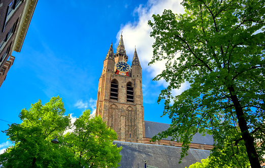 The Oude Kerk (old church) in the city of Delft in The Netherlands on a sunny day.