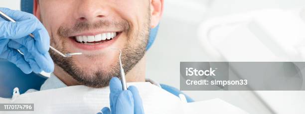 Young Man At The Dentist Stock Photo - Download Image Now - Smiling, Toothy Smile, Men