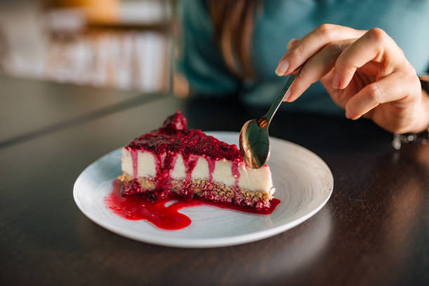 istock Woman eating delicious cheesecake, close-up, copy space. 1170175785