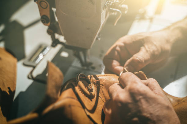 istock Working process of leather craftsman. Tanner or skinner sews leather on a special sewing machine, close up 1170176637